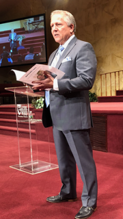 Jim speaking from a church pulpit