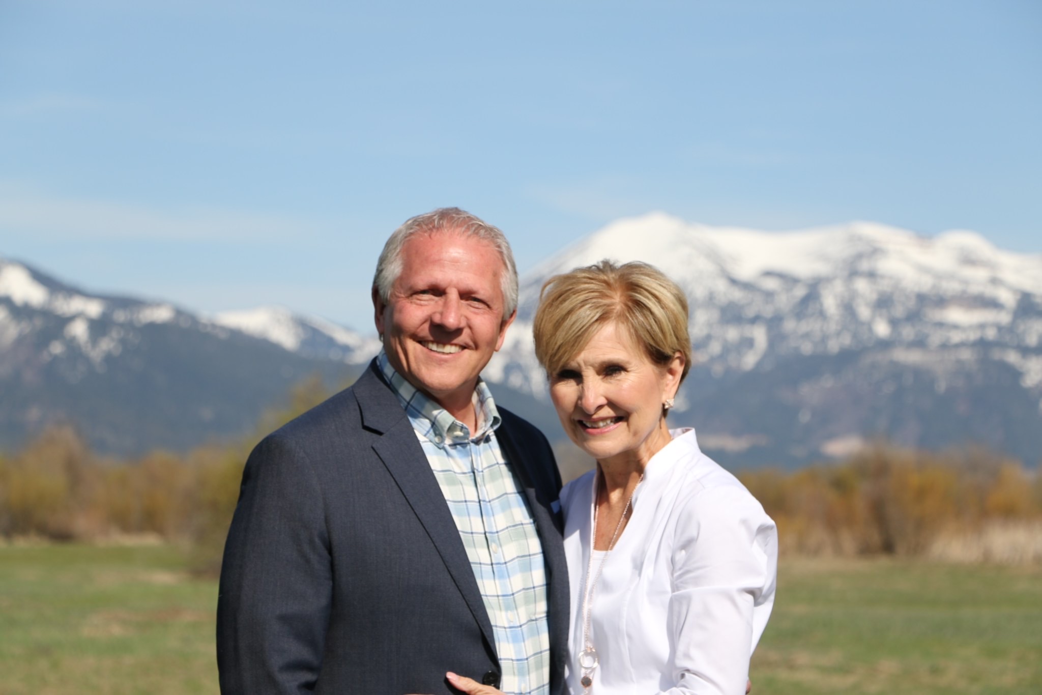 Jim and Sheree standing together in the mountains